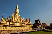 Vientiane, Laos - Surrounded by a cluster of pointed minor stupas the huge Pha That Luang shined under the warm light of the sunset.  